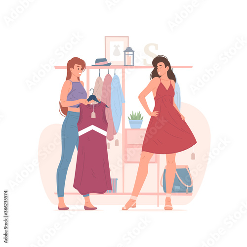 Female friends choosing clothes in shop together