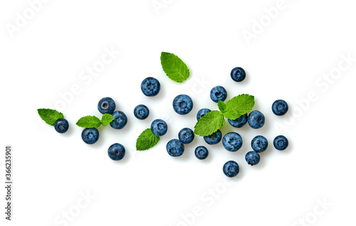 Blueberry isolated on white. Fresh blueberry closeup, healthy diet concept. Ripe organic bilberry, mint leaf creative composition. Juicy blueberries background, top view.