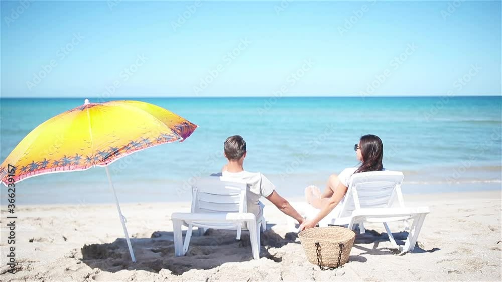 Young couple on white beach during summer vacation. Young couple on white beach during summer vacation.