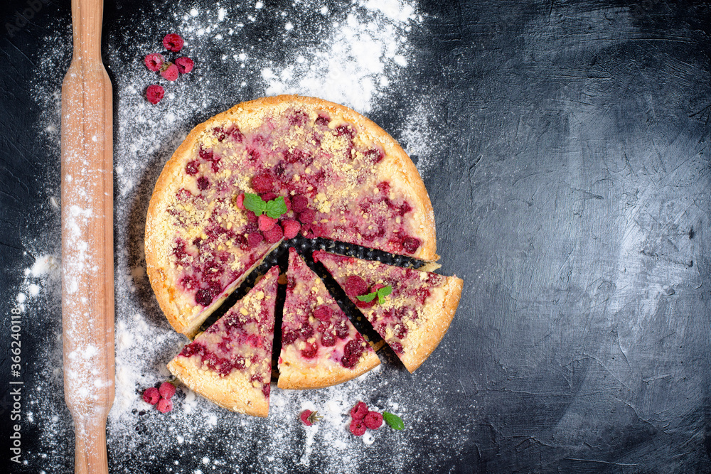 raspberry pie with ripe raspberries in home cooking with cottage cheese on a dark background, top view place for text