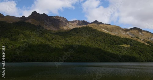 Tight Panning shot of North Mavora Lake with forests and mountains around it. Mavora was used as a location in Lord of the Rings, LOTR. New Zealand, South Island. photo