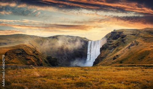 Incredible Icelandic Landscape. Famous Skogafoss waterfall with colorful sky during sunset. Skoga river, highlands of Iceland, Europe. Iceland the country of best Incredible nature locations. © jenyateua