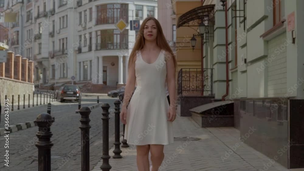 slow motion. extra long shot. an attractive girl walks around the city, a girl confidently strides along the old street of a small town. FullHD slow motion. extra long shot. an attractive girl walks around the city, a girl confidently strides along the old street of a small town. FullHD