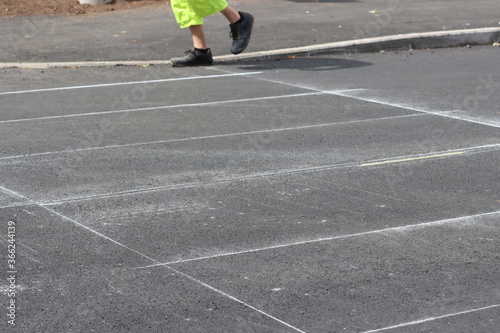 Asphalt road. Thermoplastic road marking. Preliminary marking with chalk