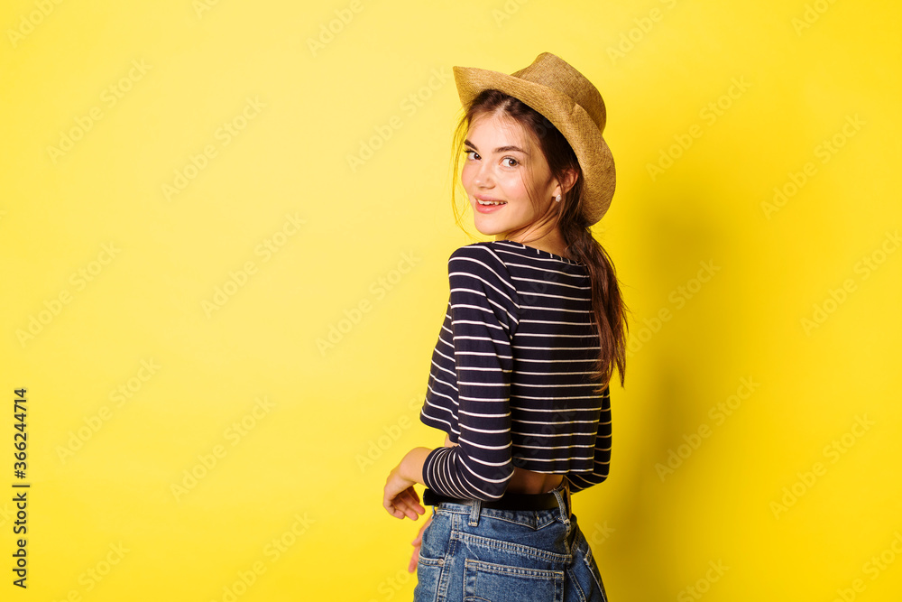 Portrait hipster beauty girl in hat on yellow background Portrait hipster beauty girl in hat on yellow background