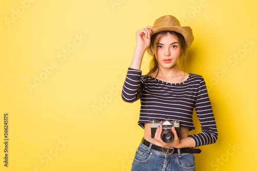 Woman photographer beauty caucasian brunette young girl on yellow background 