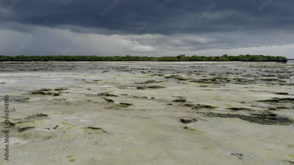 Aerial shot. Flying by the Shallow Shelf sandy caostline in Stormy Weather at Tropical island Pemba at Zanzibar Archipelago. Aerial shot. Flying by the Shallow Shelf sandy caostline in Stormy Weather at Tropical island Pemba at Zanzibar Archipelago.
