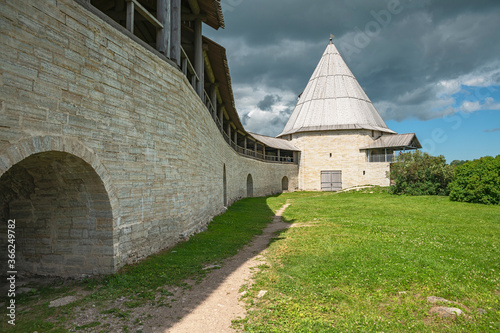 view of the stone fortress wall and the watchtower  fortress in the ancient Russian town of Staraya Ladoga