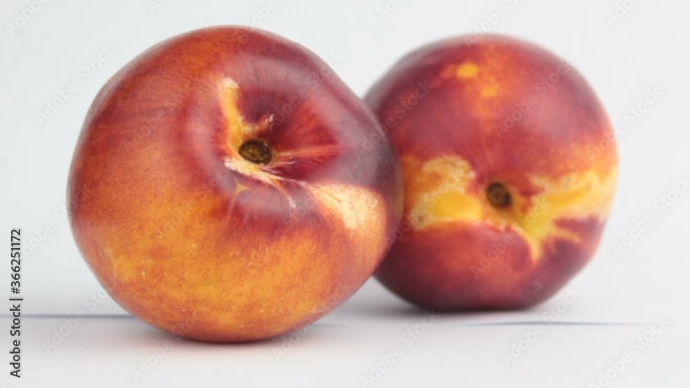 Fresh juicy peaches on a white plate. Close-up Fresh organic peaches nectarine on a white plate. Fresh juicy peaches on a white plate. Close-up Fresh organic peaches nectarine on a white plate.