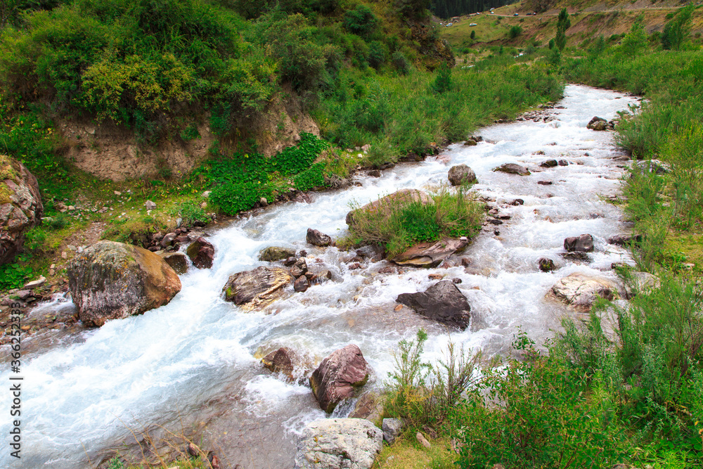 Mountain river among green mountains. Summer landscape. Mountain river among green mountains. Summer landscape.