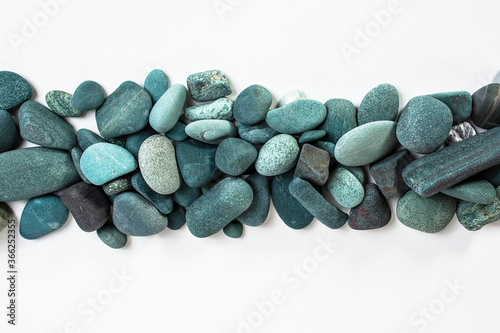 turquoise sea stones in a row on a white background
