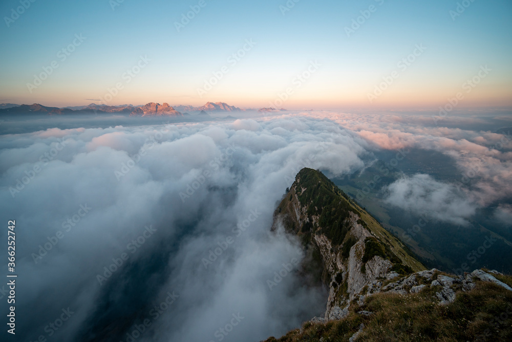 Swiss alpine peaks in clouds during beautiful sunrise
