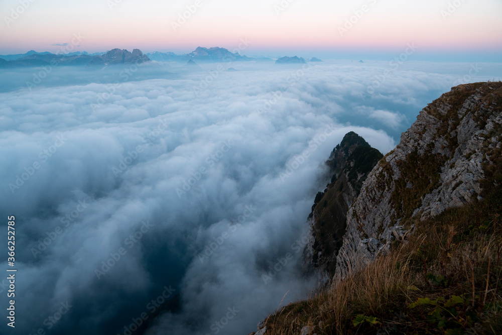 Swiss alpine peaks in clouds during beautiful sunrise