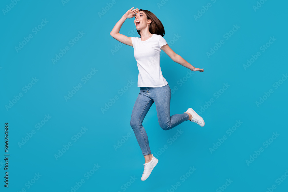 Full length body size view of her she nice attractive glad cheerful cheery girl jumping walking looking far away meet friend leisure isolated bright vivid shine vibrant blue color background