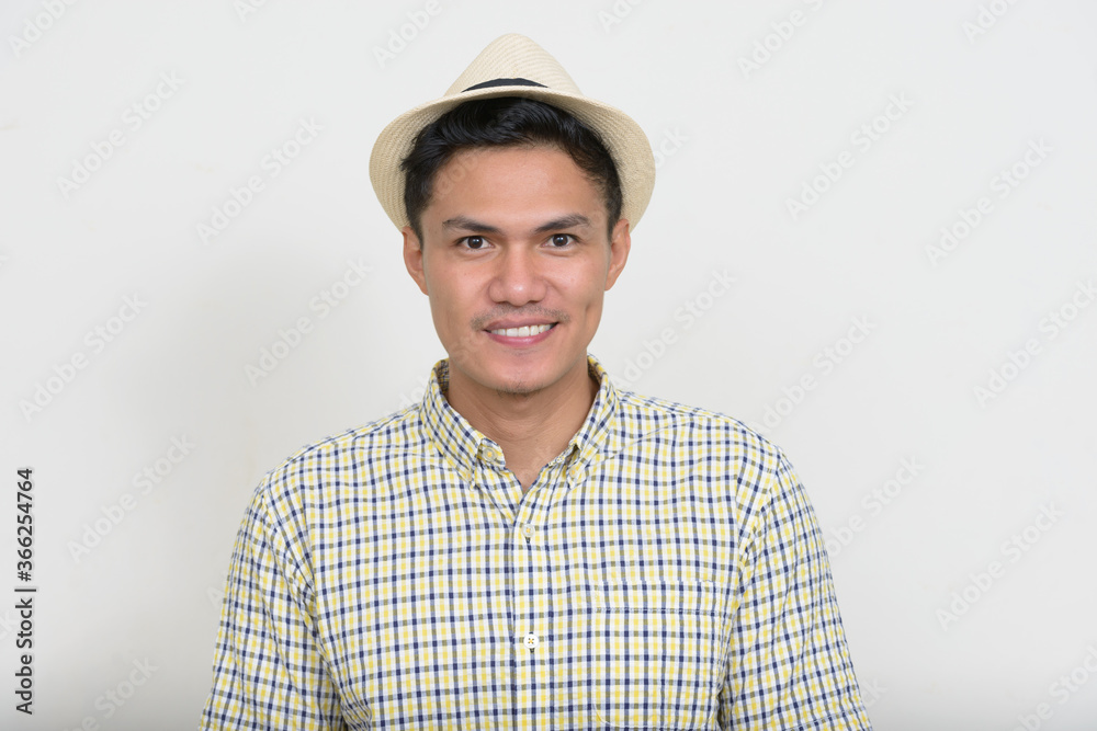 Fototapeta premium Portrait of happy handsome Asian tourist man smiling