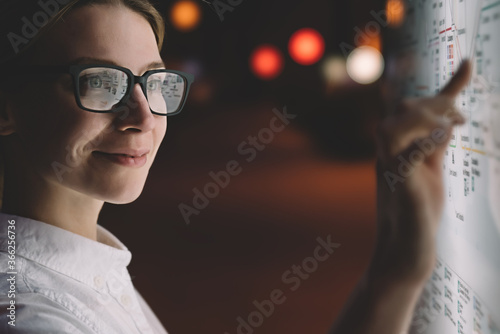Slika na platnu Female in glasses standing at display with advanced innovative technology