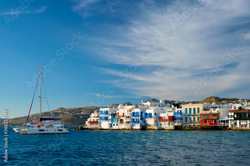 Sunset in Mykonos island, Greece with yachts in the harbor and colorful waterfront houses of Little Venice romantic spot on sunset and cruise ship. Mykonos townd, Greece © Dmitry Rukhlenko