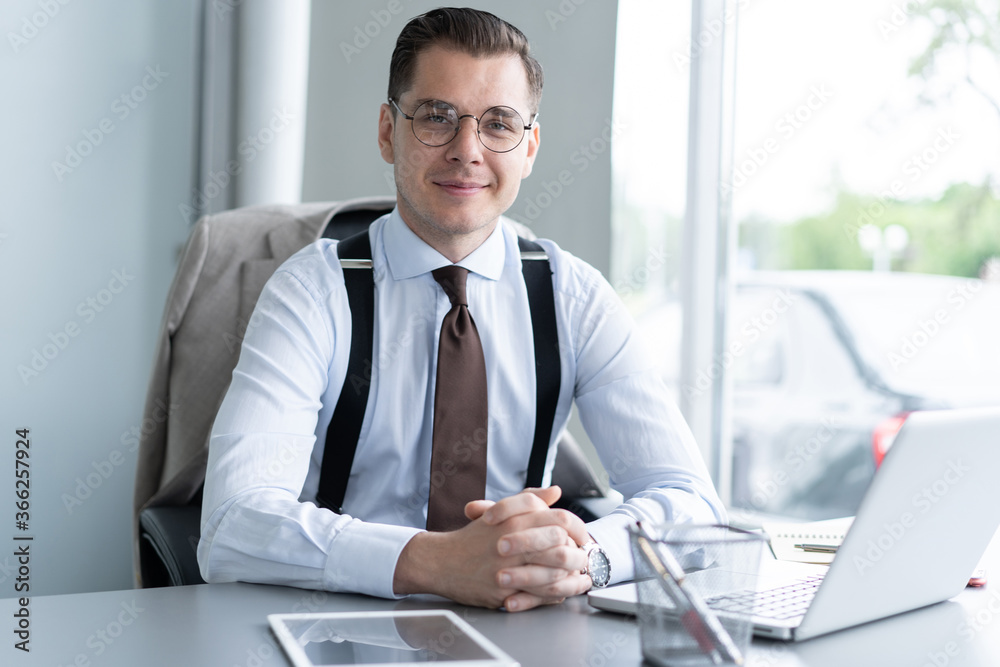 Handsome businessman working with laptop in office Handsome businessman working with laptop in office
