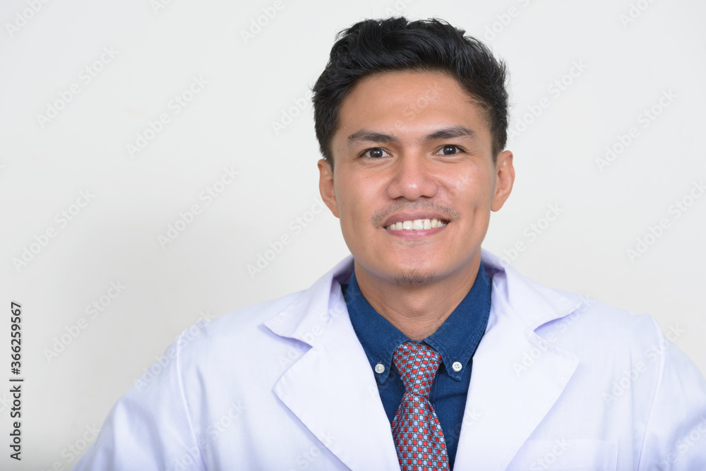 Portrait of happy handsome Asian man doctor smiling Portrait of happy handsome Asian man doctor smiling