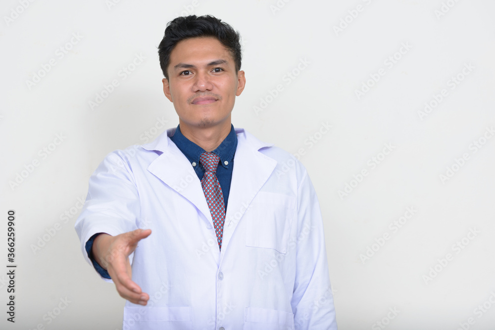 Portrait of handsome Asian man doctor giving handshake Portrait of handsome Asian man doctor giving handshake