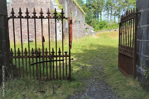 The entrance gates to the abandoned Protestant Christ Church building at Toormakeady, County Mayo, Ireland. photo