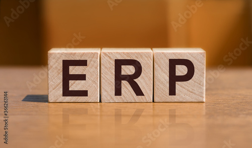 acronym ERP enterprise recource planning text on wooden blocks isolated on yellow background. Business software concept