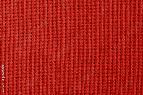 fabric with abstract pattern. red fiber texture polyester close-up. fine grain felt fabric background