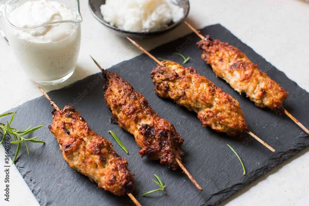Homemade kebabs served with garlic sauce and rice.