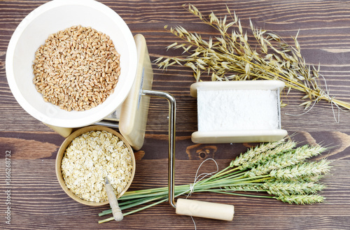 A small grain grinder on a wooden background. Traditional wheat and grain grinder used to grind grain and make flour of wheat and rice. Czech Republic, Europe. photo