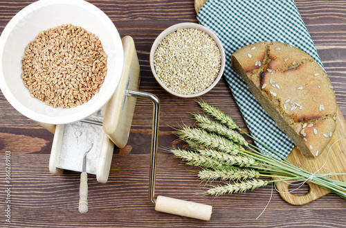 A small grain grinder on a wooden background. Traditional wheat and grain grinder used to grind grain and make flour of wheat and rice. Czech Republic, Europe. photo