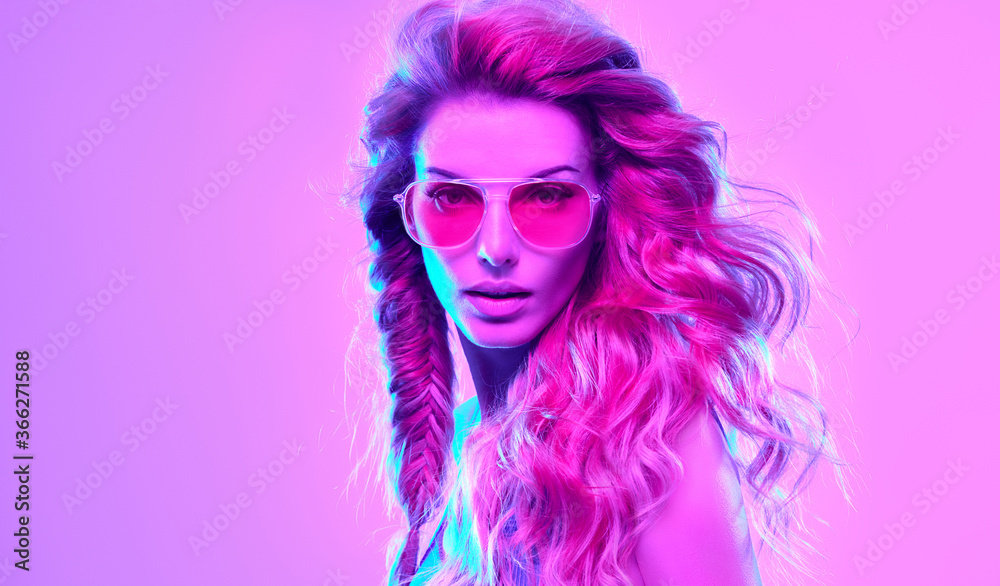 Fototapeta High Fashion. Woman in colorful neon light, make-up. Sexy girl, stylish hair, trendy makeup. Party disco pink purple neon style. Creative art beauty portrait, fashionable model face, make up