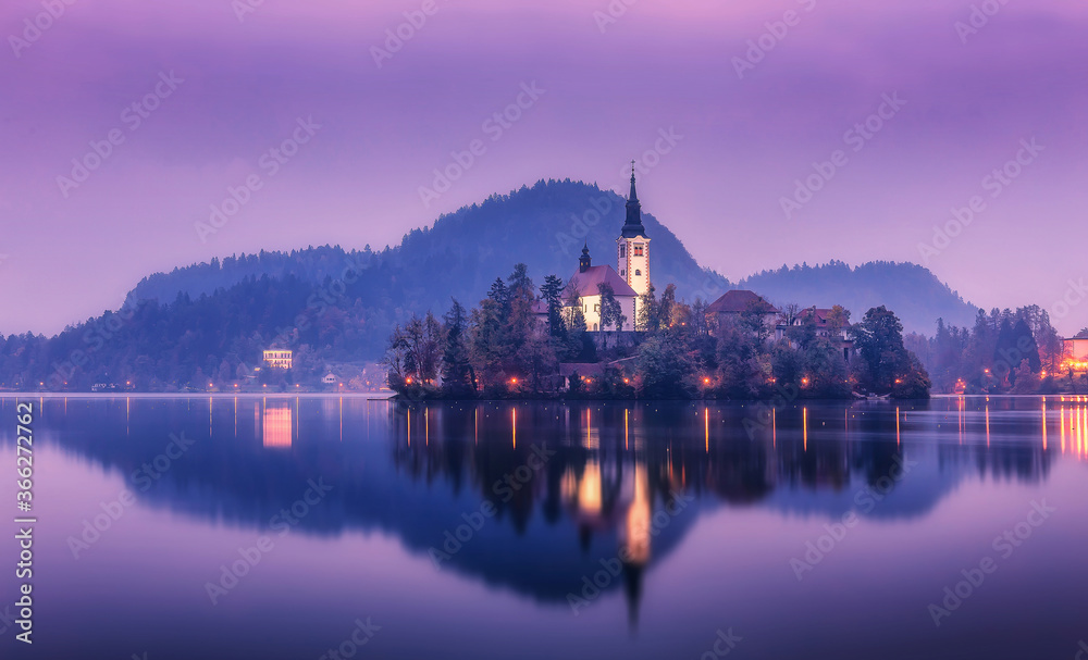 Impressive morning landscape over Bled lake. Beautiful mountain lake with small Pilgrimage Church. Most famous Slovenian lake Bled and island with Pilgrimage Church of the Assumption of Maria