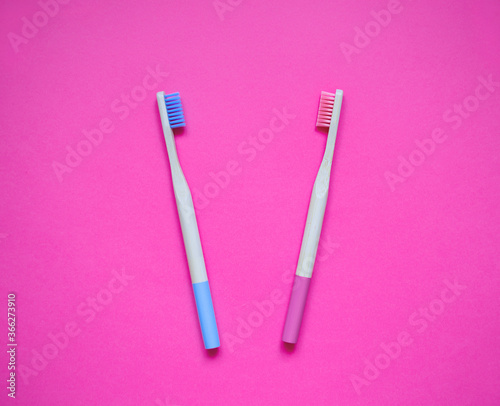 eco-friendly bamboo teethbrush on a pink background