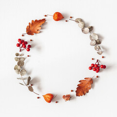Autumn composition. Wreath made of dried flowers, eucalyptus leaves, berries on gray background. Autumn, fall, thanksgiving day concept. Flat lay, top view