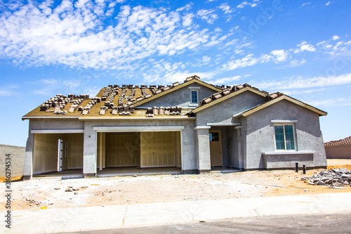 Brand New Stucco Home Under Construction With Three Car Garage © Tom