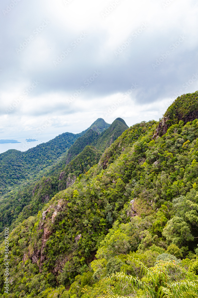 The Sugarloaf Mountain at the malaysian Island of Langkawi. scenic view of the landscape of the island in northern Malaysia. Rainforest to the mountain top, clouds roar over the tree tops