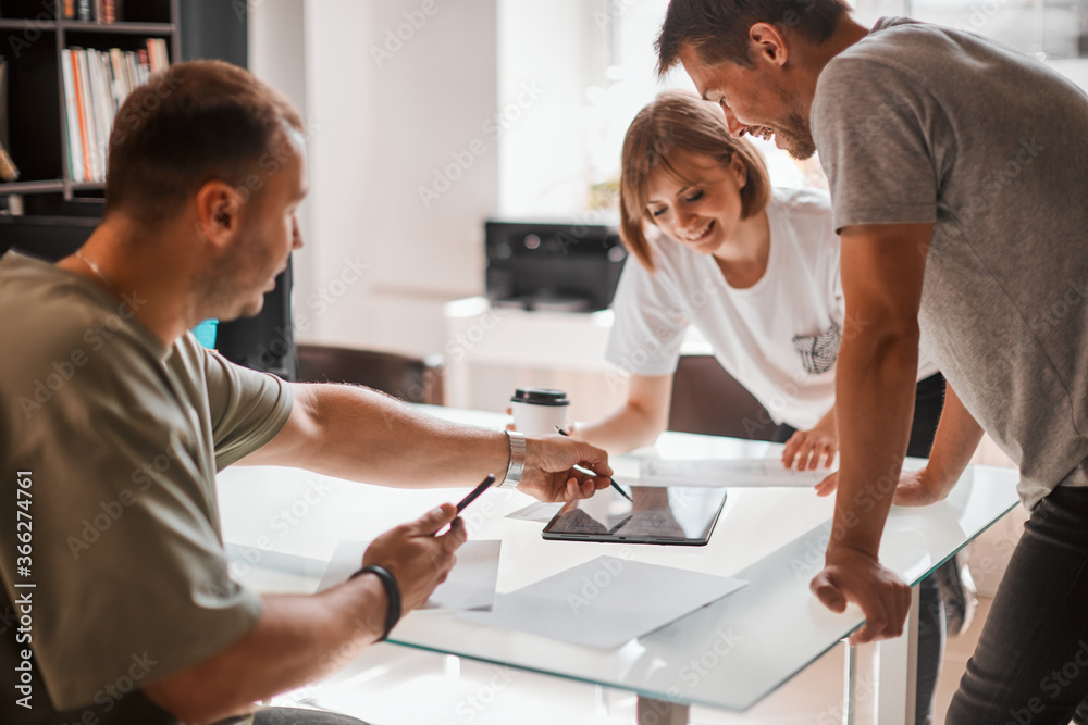 Fototapeta premium Young creative team of designers is developing a new interior project in modern creative studio
