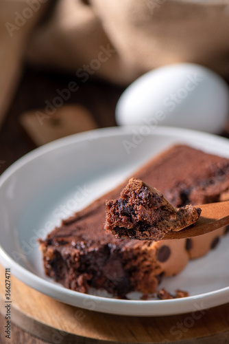 Chocolate flavor Taiwanese traditional sponge cake (Taiwanese castella kasutera) on a wooden tray background table with ingredients, close up. photo