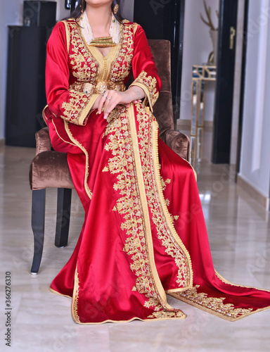 Moroccan red caftan with golden painting. The caftan is the uniform in the Maghreb 