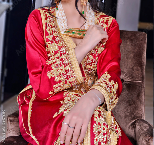 Moroccan red caftan with golden painting. The caftan is the uniform in the Maghreb 