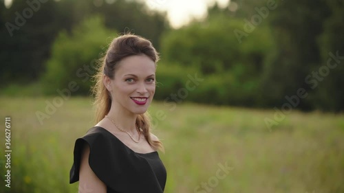 Beautiful young woman smiling in nature. Outdoors portrait