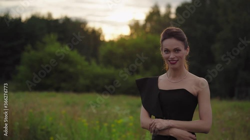 Carefree young woman relaxing in summer park outdoor