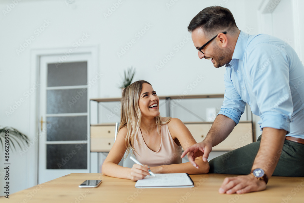 Smiling couple of coworkers working on ideas together, portrait. Smiling couple of coworkers working on ideas together, portrait.