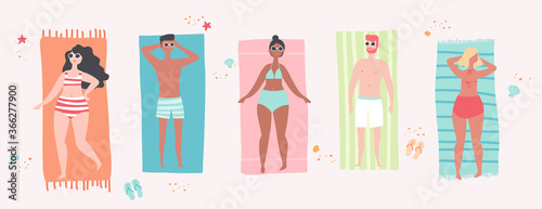 Young men and women sunbathing on the beach