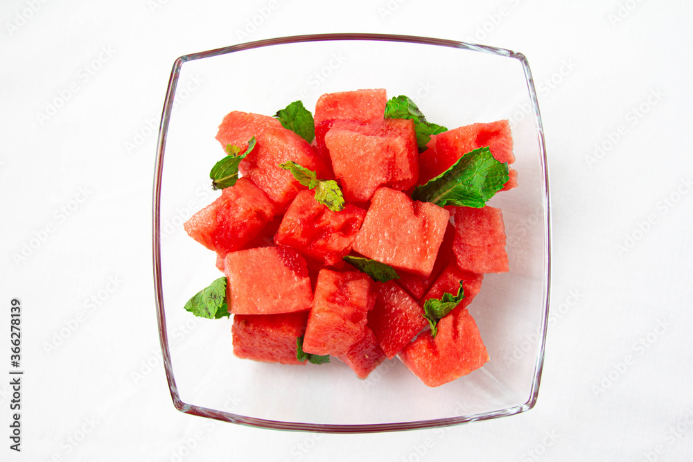 Watermelon cubes with mint close-up on white background Watermelon cubes with mint close-up on white background