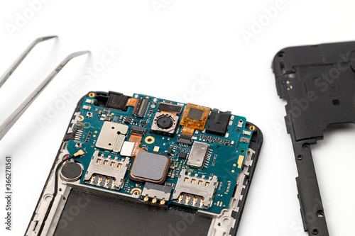 Mobile phone repair. Disassembled smartphone before repair. Smartphone repair and service concept.