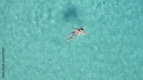Wallpaper Mural Aerial view of a couple swimming towards each other on a crystal clear water on Losinj Island, Croatia. Turquoise water.  Torontodigital.ca