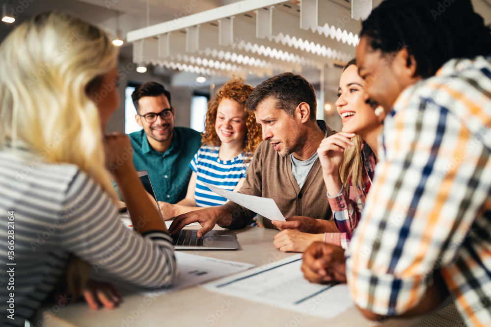 Group of diverse designers, business people brainstorming on meeting in office