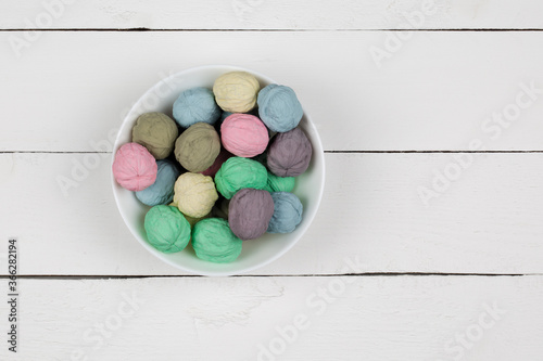 Colored nuts in a bowl on a white background