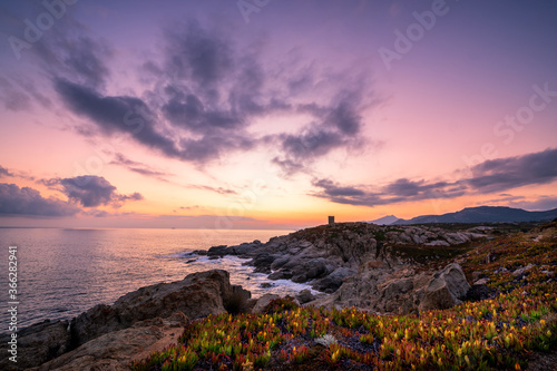 Dawn breaking behind genoese tower in Corsica